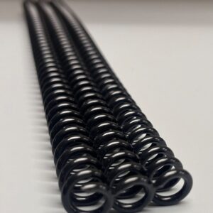 Close-up of two 5/16" x 12" #4 black plastic coils (2 pieces per pack) arranged parallel on a white surface.