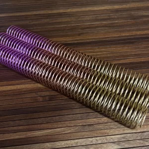 A single 30mm x 12" #4 Peach Rainbow Spiral coil graces a wooden surface, showcasing its vibrant hues.
