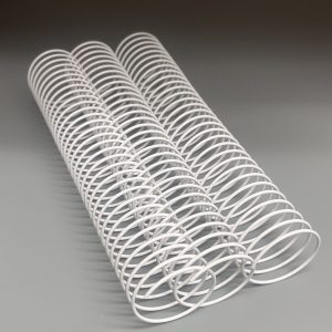 Two white, coiled wire springs aligned parallel on a smooth gray surface.