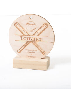 Wooden plaque with crossed bats and a baseball, engraved with "Torrance Area Chamber of Commerce.