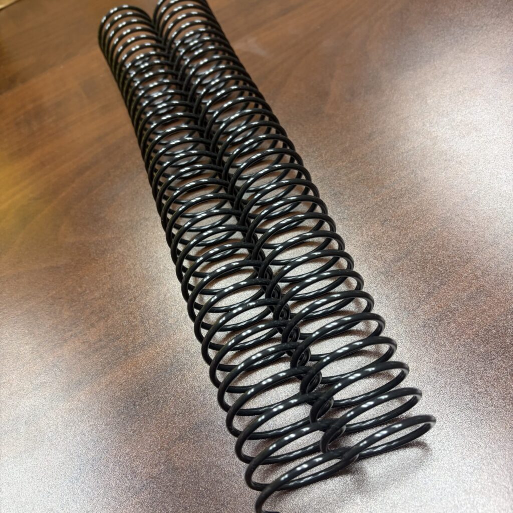 Two 1+3/8″ x12″ #2.5 Black Spiral Plastic binding coils.