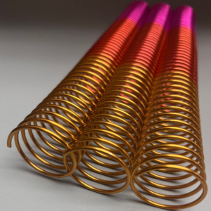 Three 1+1/4″ x12″ #4 Remix Peach wire binding coils with a gradient transition from gold to red to pink.